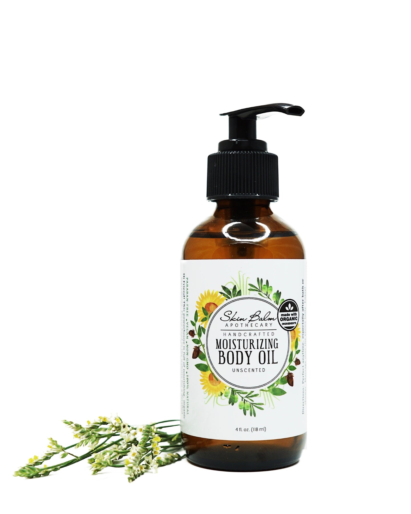 Unscented Moisturizing Body Oil with green foliage against a white background.