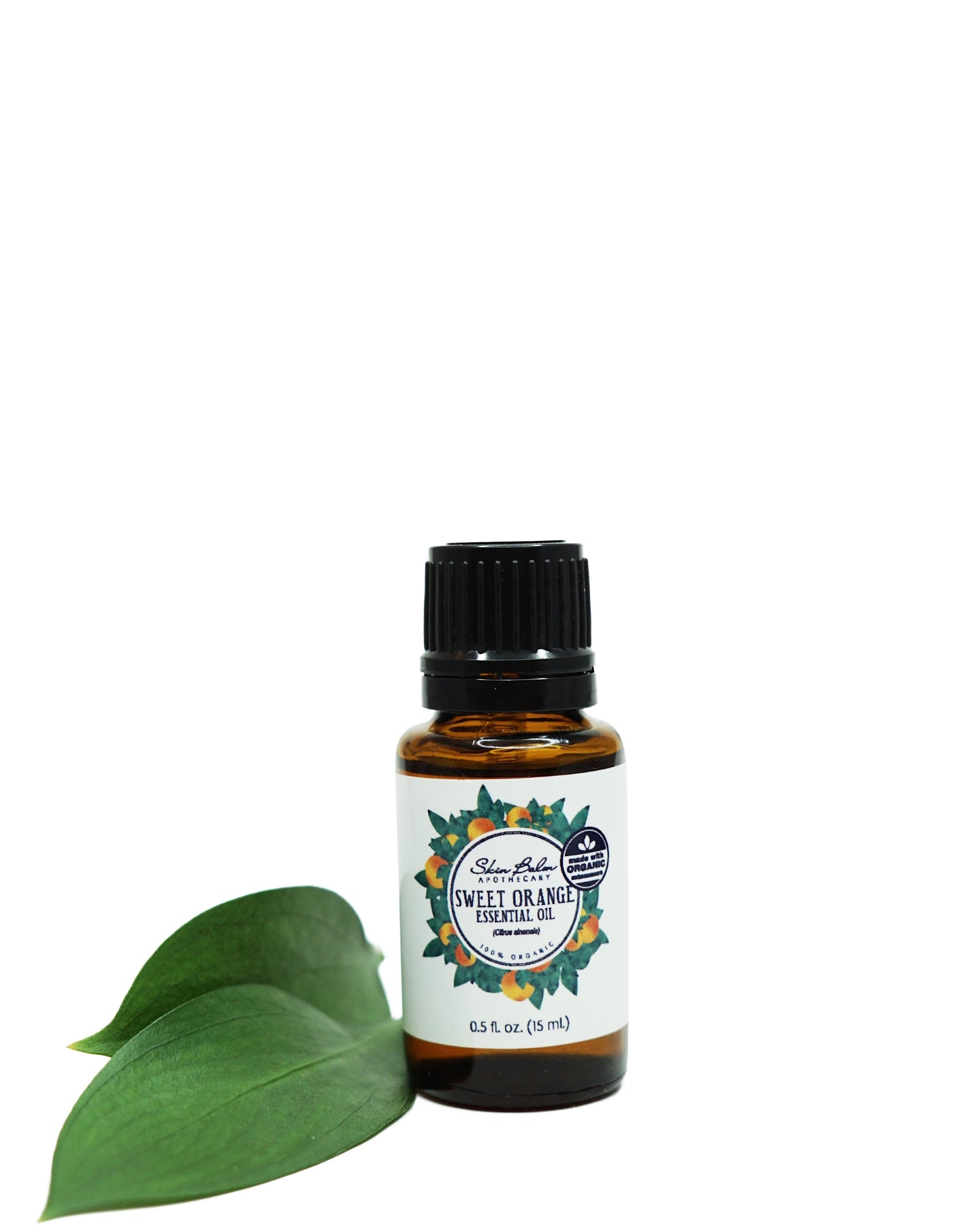 Organic Orange Essential Oil with green leaf against a white background.