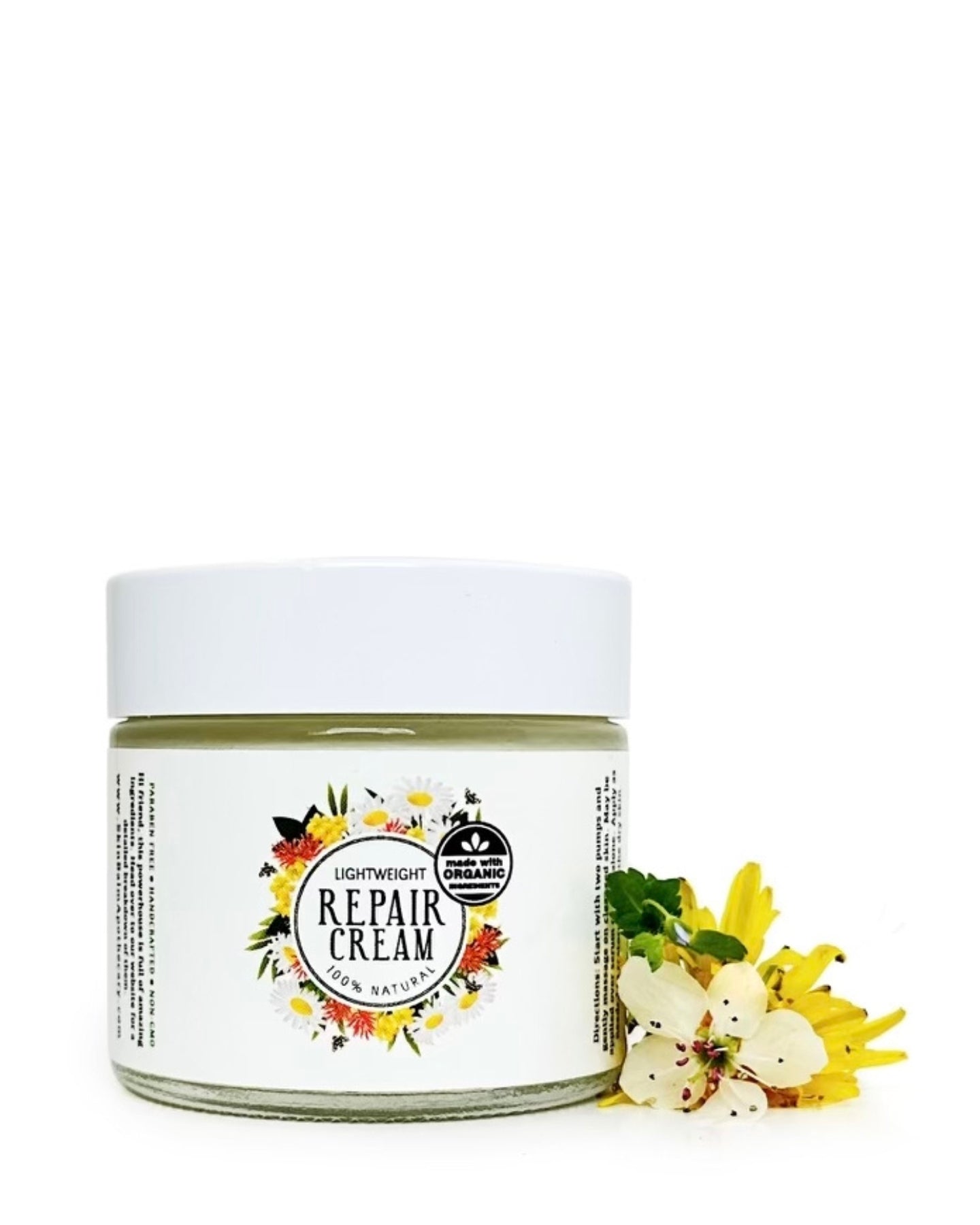 Repair Cream with white and yellow flowers against a white background.