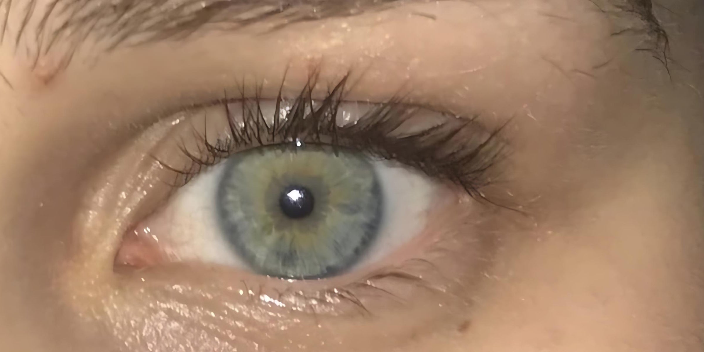 A close-up photo of a woman's eye after using The Eye Balm™.