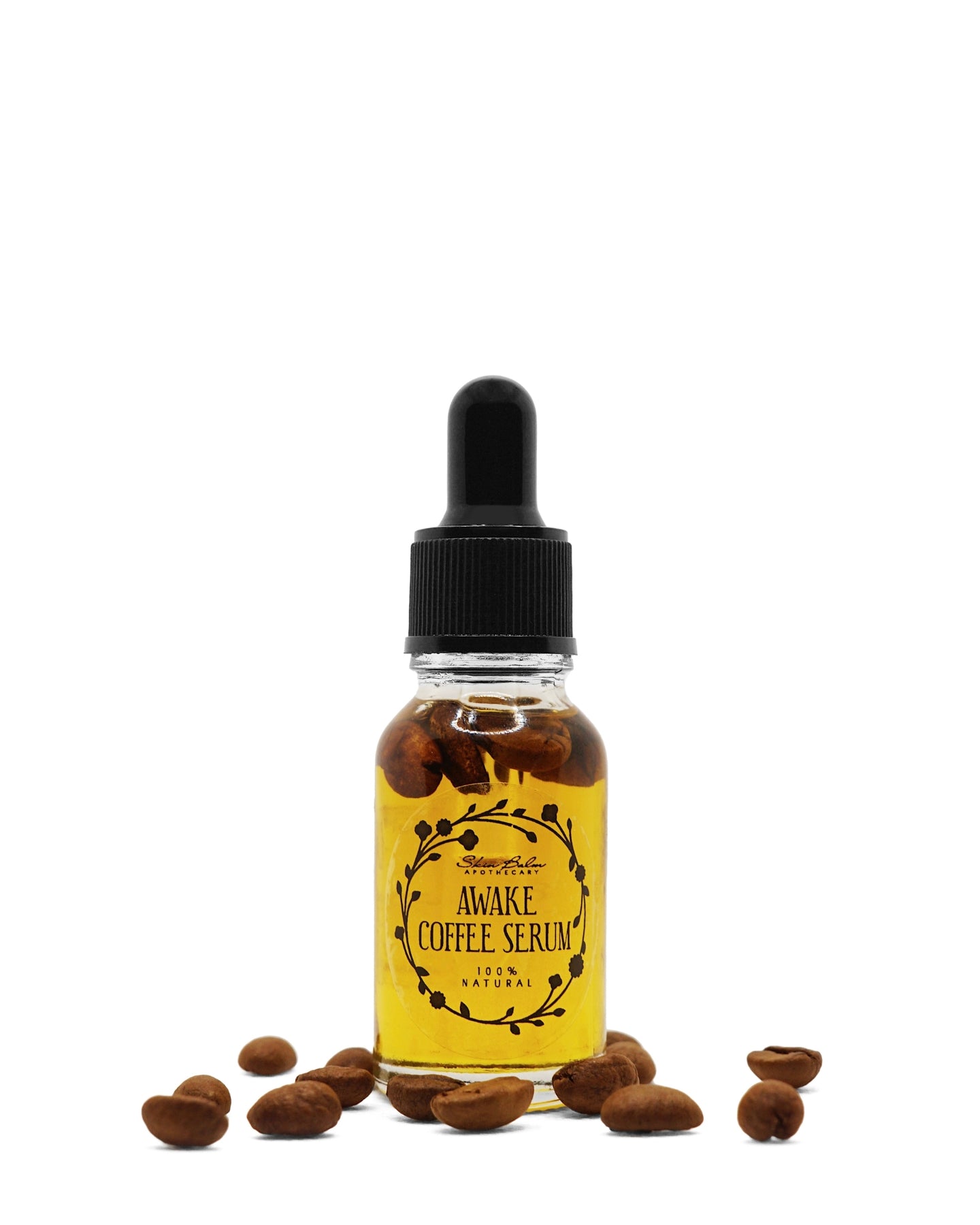 Awake Coffee Serum surrounded by coffee beans against a white background.